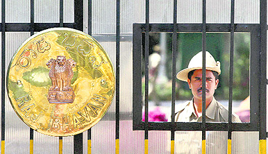 A security person guards the Raj Bhavan gate during the Karnataka bandh against Governor HR Bhardwaj in Bangalore on Saturday.