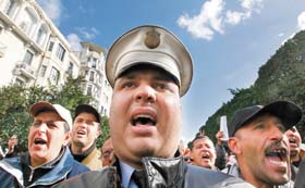Uniformed Tunisian policemen chant slogans during a protest in Tunis