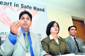 Dr Chetan Sharma of Bharat Heart Institute (left) addresses a press conference in Dehradun