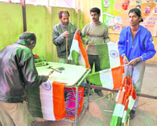 Workers make a National Flag for the Rashtriya Ekta Yatra of the BJP in Jammu on Sunday.