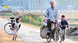 Children alongside a vegetable seller at Sekhewal village.