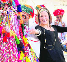 A foreign delegate shakes a leg with Rajasthani artistes during the Jaipur Literature Festival at Diggi Palace in Jaipur on Sunday.