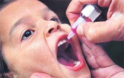 A child receives anti-polio vaccination drops by a health worker as part of a polio vaccination campaign, in Amritsar on Sunday.