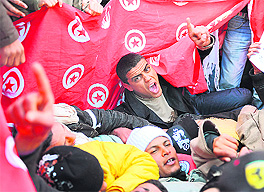 Inhabitants of the central Tunisia region of Sidi Bouzid shout slogans during a demonstration in front of the government palace in Tunis on Sunday.