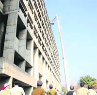 Firemen use hydraulic ladder platform to control the fire on the 9th floor of the Punjab and Haryana Secretariat building in Sector 1, Chandigarh, on Monday.