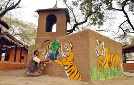 An artiste makes a painting at Surajkund Craft Mela in Faridabad. 