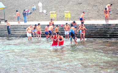 Devotees take a holy bath in the Ganga at Har-ki-Pauri in Haridwar on Monday.
