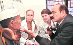 Dr BC Ramola, eye surgeon, gives tips to interns from the USA at the Doon Hospital on Monday.
