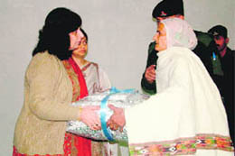 Shashi Sibal, chairperson of Family Welfare Organisation of Vajra Corps, felicitates war widows in Jalandhar Cantonment on Monday.