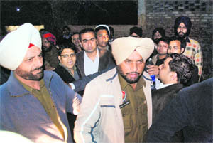 A cop being dragged by his colleague following heated arguments near the Rivera in Ludhiana on Sunday night.