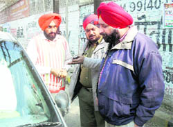 Cops look at a broken windshield near the Civil Hospital in Ludhiana on Monday. 