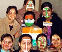 JAI HIND: Students paint their faces for a function organised at Polytechnic College in Faridabad on the eve of Republic Day