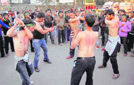 Shia younsters beat themselves with chains during a procession taken out on the occasion of Chehlum in Dehradun on Tuesday.