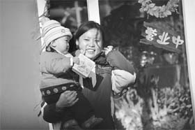 A mother holds her baby on a street in Beijing. A book titled Battle Hymn of the Tiger Mother, by Chinese-American Yale University law professor Amy Chua , about her no-nonsense child-rearing has sparked an online flurry of criticism and debate over strict Chinese parenting methods versus more relaxed Western ways