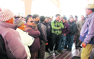 Passengers protest at the Kullu airport against the non-landing of helicopters in Lahaul, on Tuesday. 