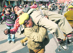 A policeman detains a BJP activist during a protest against the state government in connection with the Rashtriya Ekta Yatra in Jammu on Tuesday. 