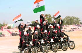 Security personnel hold aloft the Tricolour during rehearsal for Republic Day at MA Stadium in Jammu.