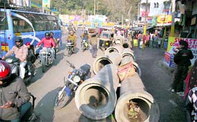Drain pipes lie along a roadside near Gumat Road in Jammu causing inconvenience to shopkeepers and commuters.