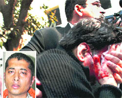 Rajesh Talwar being rushed to hospital after he was attacked outside a Ghaziabad court on Monday; and (inset) the assailant.