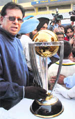 Ex-cricketer Karsan Ghavri, who played in the second World Cup in England, poses with the ICC World Cup Trophy at the PCA grounds in Mohali on Wednesday
