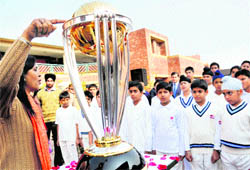 Players of the Strawberry Cricket Academy take a look of the ICC World Cup Trophy at Strawberry Fields Wonder School, Sector 26, Chandigarh, on Thursday