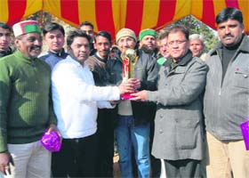 The administration team poses with the trophy of the goodwill cricket match in Mussoorie
