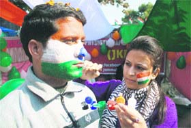 Members of the Jammu and Kashmir Physiotherapists Association paint their faces with the National Flag in Jammu