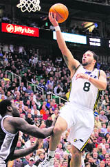 Utah Jazz guard Deron Williams (8) shoots over San Antonio Spurs forward DeJuan Blair (45) during their game in Salt Lake City, Utah, on Wednesday.