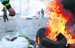 Egyptian demonstrators burn tyres during a demonstration in Suez