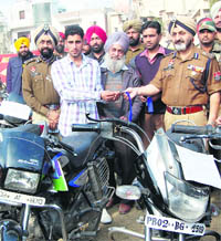 DGP P.S. Gill hands over the motorcycle keys to its owner in Amritsar on Friday