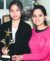 Arshdeep Kaur (left) of BBK DAV College for Women shows her trophy in Amritsar