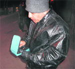 An energy auditor checks the level of light through a lux meter in Mussoorie.