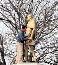 An MC worker paints the sculpture of the Father of the Nation ahead of the death anniversary of Mahatma Gandhi on the Ridge in Shimla on Friday.