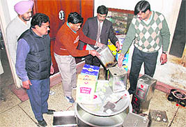 A team of Health Department officials conduct a raid on a factory manufacturing spurious desi ghee in Jalandhar on Friday. 