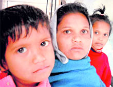 Parvati, widow of Santosh, who lost his life while fighting a terrorist, flanked by her children