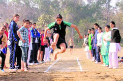 A girl takes part in long jump during the annual athletics meet of Government College for Women, Ludhiana