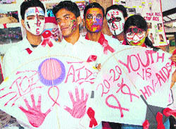 Members of the Red Ribbon Club paint their faces and posters with slogans on AIDS awareness on the occasion of Youth Day in Dharamsala on Saturday