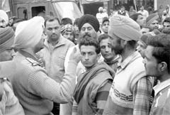 Police officials pacify irked residents, who blocked the Dera Bassi-Barwala link road due to the non-supply of LPG cylinders. 