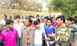 An Army official talks to youngsters during their visit to the Rock Garden in Chandigarh on Sunday. 