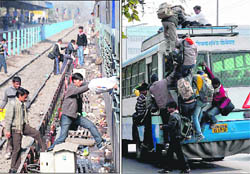Candidates cross the track between two platforms; and (right) aspirants climb atop a bus in Chandigarh on Sunday.