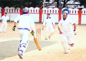 Players make a run in a match of the 60th District Cricket League held at the Survey Grounds in Dehradun