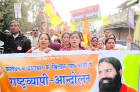 Supporters of yoga guru Ramdev take out an anti-corruption rally as part of the nationwide campaign in Dehradun