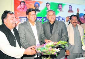 Congress legislator Pritam Singh (centre) being felicitated at the Congress Bhawan in Dehradun