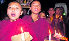 Tibetans take out a candle-light march at Sidhbari near Dharamsala on Sunday evening.
