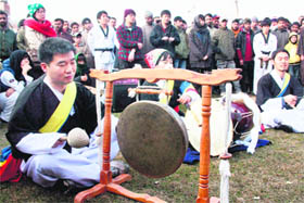 South Korean tourists give a performance at a park in Srinagar on Sunday.