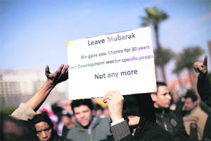 A protester holds a sign during a protest against Hosni Mubaraks regime in Cairo on Sunday. 