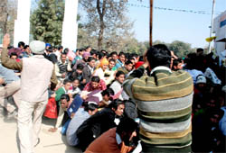 A cop charges at job applicants in the Police Lines, Bathinda, on Monday. 