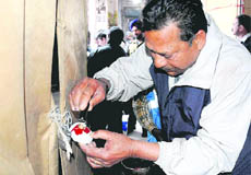 An MC enforcement official seals a shed at the Sector 19 Sadar Bazaar in Chandigarh on Monday.