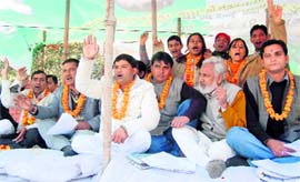 UKD workers hold a dharna in front of the office of the Garhwal Mandal Vikas Nigam in Dehradun on Monday.