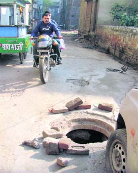 WAITING FOR ANOTHER TRAGEDY: An open manhole near Mehmi Hotel in the Bhaduar House area in Ludhiana